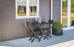 a table and two chairs on a porch at Holiday Home Syrenvej Skjern Ix in Skjern