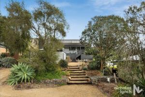 a house with stairs in front of it at Sea Haven, A Rye Coastal Retreat! in Rye