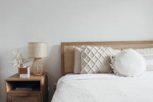 a bedroom with a bed and a night stand with a lamp at Sea Haven, A Rye Coastal Retreat! in Rye