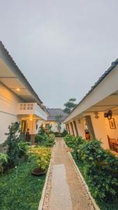 a walkway in a courtyard of a building with plants at CERIA HOTEL at Alun Alun Yogyakarta in Yogyakarta