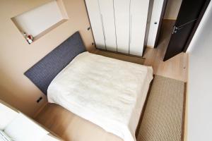 a small bedroom with a bed in a small room at Apartments Kiselyova in Minsk