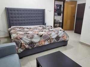 a bedroom with a bed with a quilt on it at Luxury 3 BHK family vacation home in Dubai