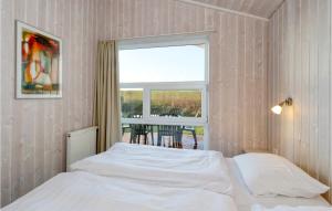 Schlafzimmer mit einem Bett, einem Fenster und einem Tisch in der Unterkunft Friedrichskoog-strandpark 15 in Friedrichskoog