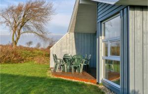 a patio with chairs and a table on the side of a house at Friedrichskoog-Strandpark 15 in Friedrichskoog