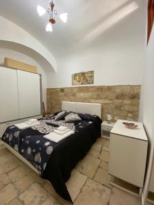 a bedroom with a bed and a table in it at Home Sweet Home rooms in Bari