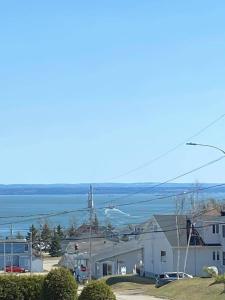 a view of the ocean from a house at Maison Carofanne in Saint-Siméon