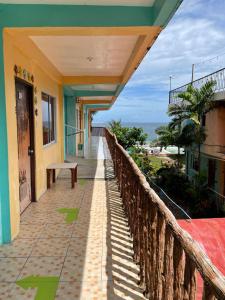 a balcony of a house with a view of the ocean at Medano Sunset Resort in Mambajao