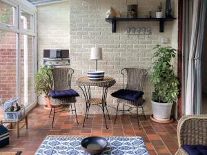 a patio with chairs and a table on a patio at Carr House in Cayton