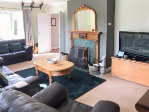 a living room with a table and a fireplace at Carr House in Cayton