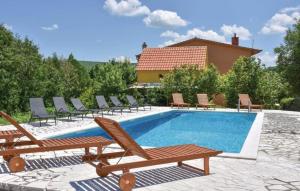 a swimming pool with chaise lounge chairs and a swimming pool at Rooms Marija - rooms with pool in Trilj