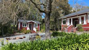 a red house with a tree in front of it at Amitabha Wine Country Cottage in Santa Rosa