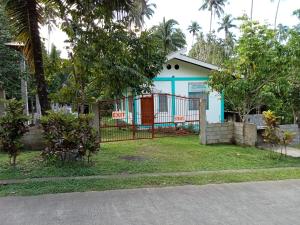 una casa con una puerta delante de un patio en RGR CAMIGUIN TRAVEL TOUR SERVICES AND PENSION HOUSE, en Mambajao