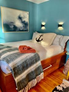 Un dormitorio con una cama con una manta. en Salt Box Hideaway, en Strahan