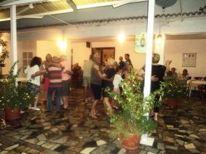 a group of people dancing in a room with plants at Guest House Marko in Seline