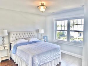 a white bedroom with a bed and a window at New Beach house - 3 Blocks to the beach!! in Long Branch