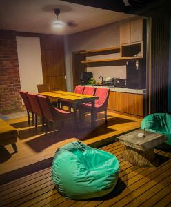 a kitchen and dining room with a table and chairs at Royale Riviera Resort Private Pool Villas in Pantai Cenang