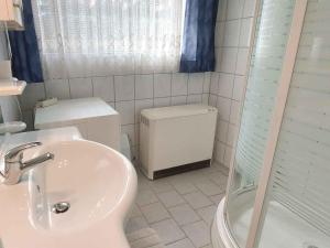 a bathroom with a toilet and a sink and a shower at Holiday home in Bad Mitterndorf - Steiermark 41125 in Bad Mitterndorf