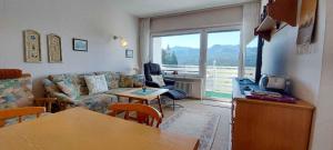 a living room with a couch and a table at Apartment in Bad Mitterndorf - Steiermark 36988 in Bad Mitterndorf