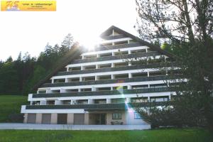 a large apartment building with the sun behind it at Studio in Bad Mitterndorf - Steiermark 41118 in Bad Mitterndorf