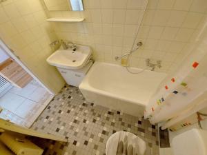 a bathroom with a toilet and a tub and a sink at Apartment in Sonnenalm - Salzkammergut 37018 in Reith +19 photos