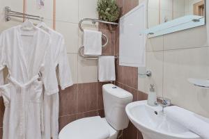 ein Badezimmer mit einem weißen WC und einem Waschbecken in der Unterkunft Vip-kvartira Kuzmy Chornogo 4 in Minsk