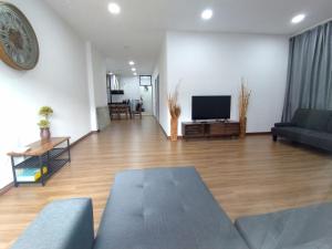 a living room with a couch and a flat screen tv at Greenery Studio, Kubot a Sentral in Tawau