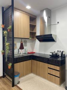 a kitchen with a black counter top in a room at Greenery Studio, Kubot a Sentral in Tawau