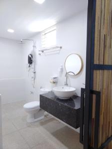 y baño con aseo, lavabo y espejo. en Greenery Studio, Kubot a Sentral, en Tawau