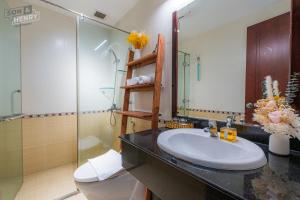 a bathroom with a sink and a toilet and a mirror at Son&Henry Sailing Tower in Ho Chi Minh City +242 photos