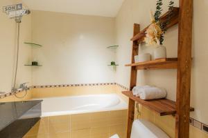 a bathroom with a tub and a toilet at Son&Henry Sailing Tower in Ho Chi Minh City