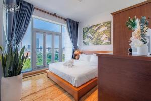 a bedroom with a bed and a large window at Son&Henry Sailing Tower in Ho Chi Minh City