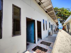 un edificio con una puerta azul a un lado en 74 Guest House Haad Rin, en Haad Rin