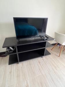 a black entertainment center with a flat screen tv on it at Sea skyline home in Sattahip