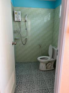 a bathroom with a toilet and a shower stall at Sea skyline home in Sattahip