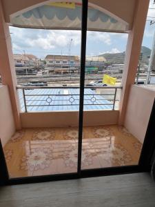 a room with a view of a balcony with a window at Sea skyline home in Sattahip