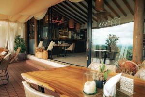 a dining room with a table and a large window at TEVA Glamping & Retreat in Rionegro