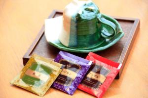 a tray with different colored packets on a table with a plate at Nest Hotel Sapporo Odori in Sapporo +16 photos