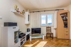 a living room with a table and a window at Apartment in Skrpcici - Insel Krk 41816 in Skrbčići