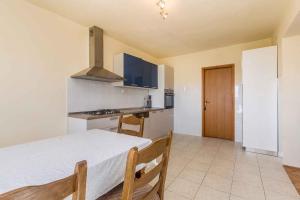 a kitchen with a bed and a stove in a room at Apartment in Skrpcici - Insel Krk 41816 in Skrbčići +12 photos