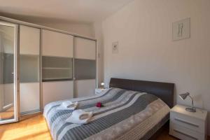 a bedroom with a large bed with towels on it at Apartments in Umag - Istrien 26738 in Umag