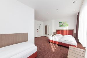 Hotel Excelsior Dortmund Hauptbahnhof tesisinde bir odada yatak veya yataklar