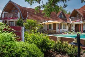 une maison avec une piscine dans une cour dans l'établissement Apartments in Balatonkeresztur 36528, à Balatonkeresztúr