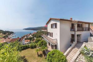 an apartment building with a view of the ocean at Apartment in Rabac 43550 in Rabac