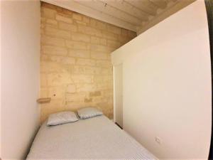 a small bedroom with a bed in the corner at L'Appart de la rue Balze in Arles