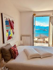 a bedroom with a bed with a view of the ocean at Suite in Baveno