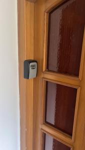 a wooden door with a thermostat on it at VIP MiKU apartman 1 in Mikulov