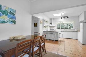 a kitchen and dining room with a table and chairs at Lovely 3BR House In Seaside Area in Williamstown