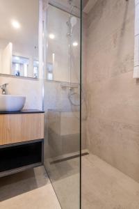 a bathroom with a glass shower and a sink at Luxury Seaview Apartment - Mare in Slano