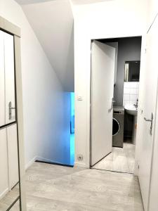 a bathroom with a door leading to a sink at Jolie appartement duplex 2 min gare-Disney et paris 15 min in Noisy-le-Grand