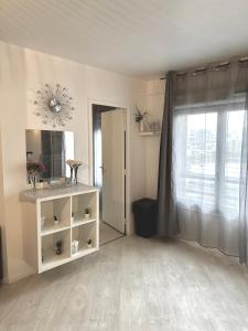 a living room with a white cabinet and a window at Jolie appartement duplex 2 min gare-Disney et paris 15 min in Noisy-le-Grand